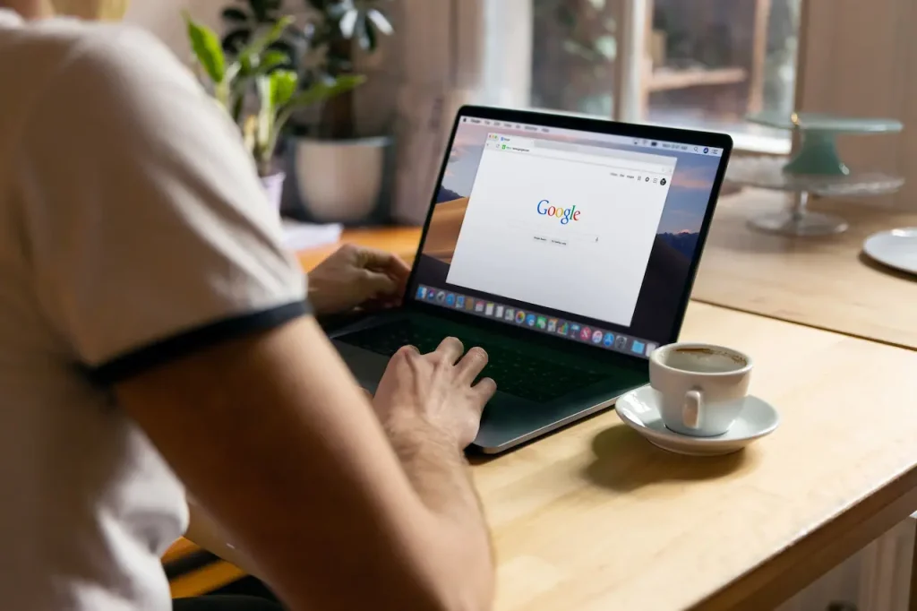 Person on his Laptop Climbing to the Top of Google Rankings