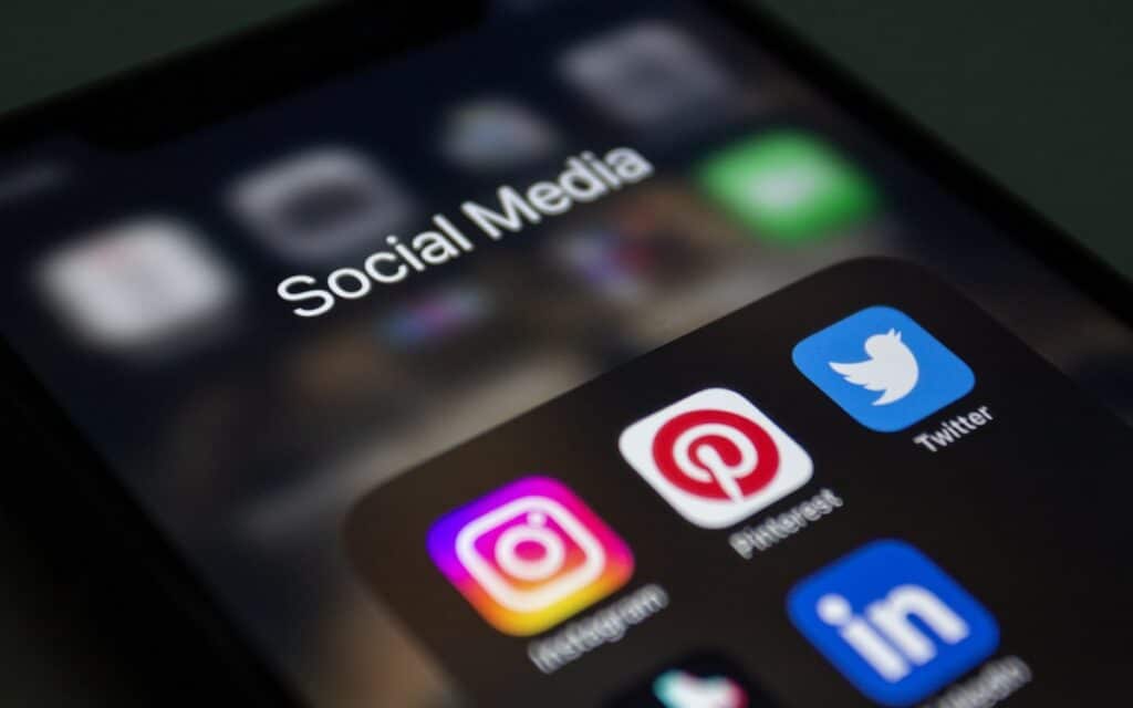 A phone showing social media app icons, representing Facebook and Instagram for a Melbourne trade business