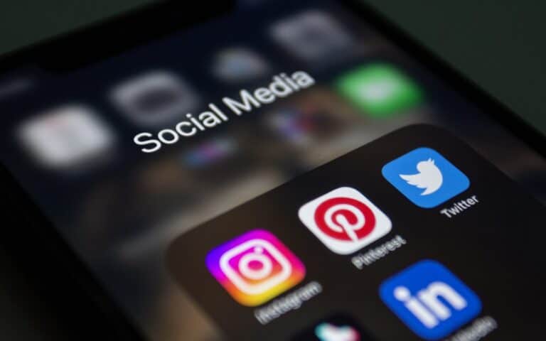 A phone showing social media app icons, representing Facebook and Instagram for a Melbourne trade business